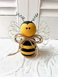 a yellow and black bee sitting on top of a white table