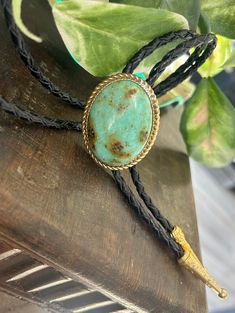 "This awesome bolo tie has a southwestern design and turquoise colored agate centerpiece. All stones are different. The cord is genuine black leather and it has gold metal detailing. Our bolos pair nicely with many of our belt buckles! They make wonderful gifts.    The western bolo tie rope length is 100cm(39\") ; charm agate stone pendant size is 5*4cm(1.97*1.57in)" Necklace Leather Cord, Western Bolo Tie, Mens Leather Necklace, Bolo Ties, Necklace Leather, Mens Necklace, Southwestern Design, Tie Gifts, Bolo Tie