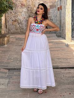 This Beautiful Strapless Dress boasts a Traditional Mexican floral design combined with a modern style dress. The corrugated skirt combined with the strapless embroidered top makes it fun and flirty. It's made out of fine Mexican corrugated cotton and has elastic on the back for a tighter fit. It has lace details throughout. This dress is handmade and completely hand embroidered by Mexican Artisans in Puebla, Mexico. More available dresses here: https://www.etsy.com/es/shop/SoleiEthnic?ref=selle Bohemian Embroidered Sleeveless Maxi Dress, Bohemian Sleeveless Embroidered Maxi Dress, Bohemian Sleeveless Embroidered Beach Dress, Bohemian Embroidered Sleeveless Dress, Bohemian Embroidered Sleeveless Fitted Dress, Sleeveless Bohemian Embroidered Dress, White Sleeveless Bohemian Embroidered Dress, White Bohemian Sleeveless Embroidered Dress, Traditional Sleeveless Summer Maxi Dress