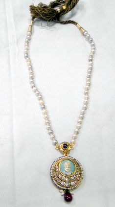 "Vintage antique 22 K solid gold and Ruby pearl Sapphire gemstone Necklace. Original old Royal piece with Maharaja (king)miniature painting inserted in very good condition. Size of pendant-3.5 cm, Length -35 cm(13.77\") end to end, free size easy to adjust the length by moving cord knot. weight-44 grams, material -22 K gold, Ruby, pearls, Sapphire." Round Pearl Pendant Necklace For Festivals, 22k Gold Temple Jewelry Pearl Necklace As Gift, Festival Pearl Pendant Necklace, Traditional Round Necklace With Pearl Pendant, Diwali Temple Jewelry Pearl Necklace, Traditional 22k Gold Necklace With Pearl Pendant, Traditional Yellow Gold Round Pearl Necklace, Traditional White Pearl Necklace With Gemstone, Traditional Gold Pearl Necklace With Gemstone