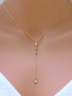 "CZ Drop in14k Gold Fill Necklace. Bridal jewelry. Layering necklace. It is sending alone and prefect for combination. All metal components onto Sterling silver . The picture length is 16\". The necklace is made of.. - 4mm 3 of 14k gold fill 3mm CZ dots, - 5mm 14k gold fill CZ dots, -14k gold fill Cable chain with spring claw. -Come up with ribbon gift box and -One Set of Care instruction package. Gold Layered https://www.etsy.com/listing/215630452/double-layered-gold-initial?ref=shop_home_activ Double Gold Necklace, Gold Cubic Zirconia Lariat Backdrop Necklace, Dainty Gold Dangle Diamond Necklace, Dainty Gold Diamond Dangle Necklace, Gold Diamond Necklace With Adjustable Chain For Wedding, Gold Dangle Bridal Necklace For Anniversary, Adjustable Yellow Gold Wedding Jewelry, Adjustable Yellow Gold Jewelry For Wedding, Gold Dangle Bridal Necklace For Wedding