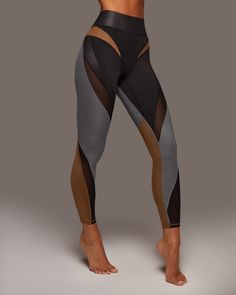 Designer's Notes Our hero legging. Color-blocking panels and sculpting mesh inserts join forces, becoming a legging you've never seen before. Crafted in Liquid Gloss fabric, for a sophisticated metallic shine. Features Sweat wicking Eight-way stretch 3" Shaperband functions as shapewear to taper the waistline and offer support and flexibility while staying light and soft Mesh inserts on thigh & lower leg Gusset designed for comfortable movement Made with Love in Canada Size & Fit High waisted Sl High Fashion Athletic Wear, Cyberpunk Workout, Futuristic Leggings, Gym Fashion, Mesh Leggings, Lower Leg, Womens Workout Outfits, Leggings Design, Athletic Outfits