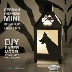 a paper model of a house with a dog's face on it and the words german shepherd mini desktop lantern