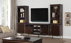 a living room with a large entertainment center and a flat screen tv mounted on the wall