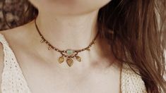 "✨ An absolute eye-catcher for your summer outfit - the macramé choker \"«Saira» adorned with brass pendants and an asymmetrical gemstone (Burma Jade). The necklace reminds me of my trip through Asia, which definitely made me a better, happier person. The name \"Saira\" has sources in many different countries. In Hindi it means \"the traveller\" and in Arabic \"cheerfulness\" / \"happiness\". All three terms are very fitting, so the naming was very easy for me. ✨  \" Material \"  waxed polyester Festival Choker Necklace With Adjustable Cord, Festival Choker Necklaces With Adjustable Cord, Handmade Bohemian Brass Choker, Hippie Macrame Choker Necklace, Adjustable Cord Choker For Festival, Handmade Bohemian Choker Necklace, Hippie Macrame Necklace For Festivals, Hippie Style Macrame Necklace For Festivals, Adjustable Bohemian Brass Choker