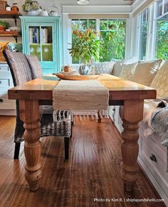 a wooden table sitting in the middle of a living room