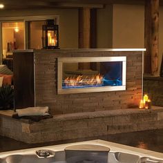 a hot tub sitting next to a fireplace in a living room