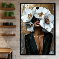 a woman with white flowers in her hair is shown on a wall above a table