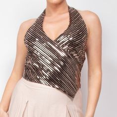 Elevate Your Evening With Our Surplice Halter Sequin Top, A Dazzling Piece That Merges Modern Nostalgia With Sophistication. Designed To Make A Memorable Impression, This Top Features A Unique Combination Of Elegance And Glamour Perfect For Any Soire. Key Features: - Fabric: 95% Polyester, 5% Spandex, Providing A Blend Of Durability, Stretch, And Comfort. - Fit: Regular Fit With A Flattering Waist-Length Cut. - Color Options: Black/Rose Gold. - Sizes: Available In S, M, And L. - Design: The Halt Glamorous V-neck Tops For Date Night, Chic Gold Halter Top For Night Out, Glamorous Halter Neck Top For Party Season, Sequin Halter Neck Top For Night Out, Chic V-neck Halter Top For Party, Glamorous Halter Neck Tops For Night Out, Fitted V-neck Top For Party, Fitted Halter Neck Top For Party, Fitted Halter Neck Party Top