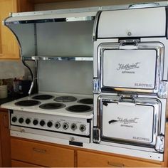 an old fashioned stove with two burners in the middle of it's cabinet