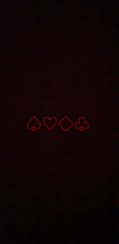 three hearts and four spades on a black background with red light in the middle