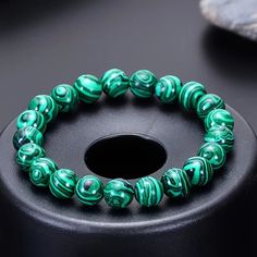 This Elegant Bracelet Features 6mm Synthetic Malachite Beads, Each Showcasing The Stone's Signature Rich Green Hues And Mesmerizing Natural Banding. The Smooth, Polished Beads Are Strung Together To Create A Timeless Accessory That Exudes Both Sophistication And A Touch Of Earthy Charm. The Bracelet You Will Receive Is A Little Darker Than The Bracelet Pictured And Is Approximately 2.20 Inches From Side To Side. Perfect For Adding A Pop Of Color And A Sense Of Tranquility To Any Outfit, This Mal Malachite Bracelet, Juicy Couture Charms, The Perfect Girl, Green Hues, Pandora Style, Opal Color, Bangle Bracelets With Charms, Rich Green, Elegant Bracelet