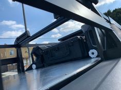 the back end of a truck with luggage on it's flatbed and windows