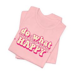 Embrace a positive mindset with our "Do What Makes You Happy" Graphic Tee. Featuring a retro pink font, this shirt is not just a piece of clothing but a daily reminder to prioritize your happiness. The uplifting message adds a touch of positivity to your wardrobe, making it an ideal choice for casual outings or a comfortable statement at home. Crafted for both style and comfort, this tee encourages you to express your individuality and live by the mantra of happiness. Spread good vibes wherever you go with this inspirational quote shirt. Grab yours now and let your clothing speak volumes about your positive outlook! Pink Relaxed Fit T-shirt With Slogan, Pink Slogan T-shirt With Crew Neck, Pink Graphic Tee With Slogan, Trendy Pink T-shirt With Funny Text, Pink Slogan Crew Neck T-shirt, Pink Crew Neck T-shirt With Slogan, Pink Relaxed Fit T-shirt With Letter Print, Relaxed Fit Pink Top With Lettering, Pink Cotton Tops With Lettering