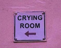 a sign on the side of a building that says crying room and an arrow pointing to the right