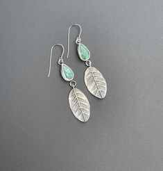 These are 100% hand fabricated earrings. These are sweet little sage leaf earrings with lovely green kyanite stones. The leaves are hand fabricated from sterling silver sheet and wire, they are handmade, and textured. The stones are set in sterling silver and the earrings have hypoallergenic ear wires. They are lightweight and swing nicely when worn. These are handmade and one of a kind earrings. They are 2 inches long and 3/4 inches wide. Green Kyanite activates your entire chakra column, howev Green Leaf-shaped Sterling Silver Earrings, Green Earring, Art Jewelry Earrings, Sage Leaf, Green Kyanite, Copper Plating, Sage Leaves, Emerald Earrings, Green Earrings