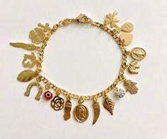 18k gold filled charm (virgin mary,elephant,evil eye,hamsa,money bag,heart,crystal ,horseshoe cross)bracelet for good luck and  protection..7.25" long . pulsera de buena suerte en18k gold filled.  para proteccion y buena suerte.7.25" largo. Money Bracelet, Horseshoe Cross, Evil Eye Hamsa, Good Luck Bracelet, Heart Crystal, For Good Luck, Pompano Beach, Protection Bracelet, Evil Eye Pendant