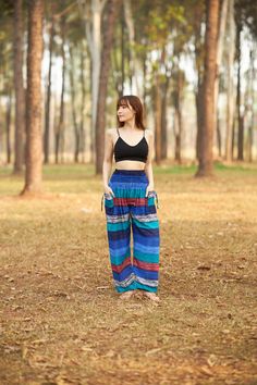 These cute hippie pants are colorful pants and handmade with rayon fabric which make them super comfy to wear. They have an elastic waist and elastic ankles. The two pockets are fitted with decorative strings. These trousers are are perfect for relaxing at home, working out, yoga running, beachwear and general casual wear. Also recommended for Thai massage, dance and festivals. Lannaclothesdesign products are uniquely designed and latest fashion trends. You can choose from many different colors Blue Flowy Pants, Colorful Pants, High Waisted Wide Leg Pants, Hippie Pants, Thai Massage, Flowy Pants, Colored Pants, Clothes Women, Pantalon Large