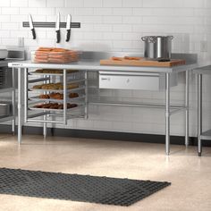 a kitchen with stainless steel counters and shelves