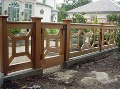 a wooden fence in front of a white house