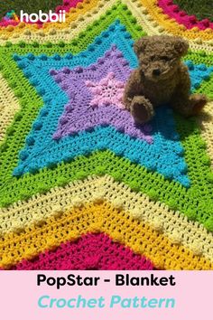 a teddy bear sitting on top of a crocheted star blanket with the words pop star blanket written across it