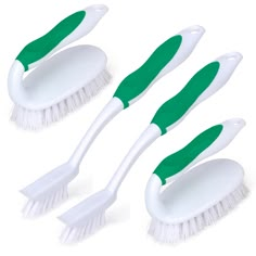 three white brushes with green handles and long bristles are shown on a white background