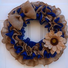 a burlap wreath with a sunflower on it