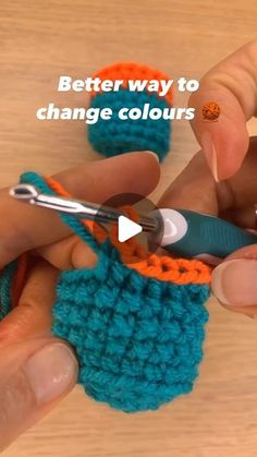 someone is crocheting something with scissors and yarn on a wooden surface that says, better way to change colours