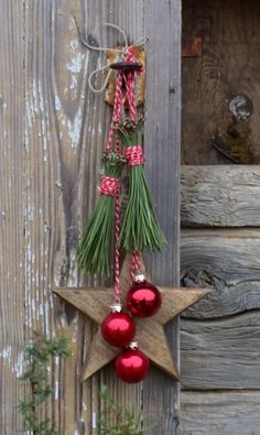 a star hanging from the side of a wooden building with ornaments on it's side