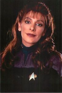 a woman with long hair wearing a star trek uniform