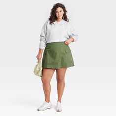 Elevate your collection of bottoms for casual occasions with this Wrap Miniskirt from Universal Thread™. Crafted from midweight cotton fabric in a regular fit, this wrap miniskirt offers a perfect balance of comfort and style. It's designed with a side button closure for a snug fit, while the flap and cargo pockets provide space for small essentials. Pair it with just about any top in your closet for a number of versatile looks. Universal Thread™: Found exclusively at Target. Cotton Skirted Shorts With Lined Skirt, Cotton Skirted Skort With Lined Skirt, Cotton Skort With Pockets For Fall, Fall Cotton Skort With Pockets, Fall Cotton Cargo Skirt With Relaxed Fit, Relaxed Cotton Skort Of Short Length, Short Length Cotton Skort With Relaxed Fit, Green Cotton Skort With Pockets, Fall Cotton Mini Cargo Skirt