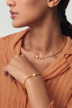 This stunning Aurora golden pearl beaded bracelet radiates elegance with its gorgeous golden sheen and luxe pearl. Divinely designed to be waterproof and tarnish proof, it's a must-have accessory for any wardrobe! Perfect for making a statement, this gold-plated masterpiece is sure to turn heads. ………………………………….D E T A I L S• Materials: Stainless steel, 18k gold plating, freshwater pearl.• Length: 17cm (6.7 inches) + extender 5cm (2 inches)• Width: 0.3cm (0.1 inch)• This product is hypoallergenic Luxury Gold Beaded Bracelets, Gold-plated Pearl Chain Bracelet, Luxury Gold-tone Pearl Chain Necklace, Gold Plated Pearl Chain Bracelet, Yellow Gold Plated Bracelets With Pearl Chain, Gold Pearl Bracelet With Oyster Detail, Gold Bracelet With Pearl Pendant As Gift, Gold Bracelet With Pearl Pendant For Gift, Yellow Gold Plated Jubilee Pearl Bracelet