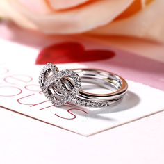 Sweet and meaningful, this fashion ring is a great choice for the one you adore. Created in sterling silver, this ring features shimmering ribbons that loop into charming open hearts and meet at the center with a coordinating band. An elegant look for your hand, this ring set sparkles brilliantly in any angle.Carat Weight: 0.51 ctStone Size: 1.1 mmStone Type: Jeulia® StoneNumber of Stones: 51 Stone Color: Diamond WhiteStone Shape: RoundWeight: 2.26 gWidth: 10 mmHeight: 4.3 mmThickness: 2.2 mmMaterial: 925 SilverPlating Color: Silver Elegant Sterling Silver Stackable Rings With Open Heart, Elegant Heart Ring For Proposal On Mother's Day, Silver Open Ring Diamond Ring For Valentine's Day, Silver Double Heart Ring For Mother's Day, Elegant Sterling Silver Heart Ring For Proposal, Elegant Silver Stackable Heart Cut Rings, Elegant Silver Heart Cut Stackable Rings, Elegant Double Heart Diamond Ring For Valentine's Day, Elegant Silver Heart Ring For Proposal