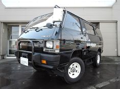 a black van parked in front of a building