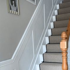 the stairs in this house have been painted white and gray with black trimmings