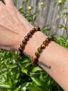 Strengthen your protection from harmful energies with this Tiger's Eye Bracelet. Tiger's eye crystals offer us protection, balance and good luck. Tiger's Eye has been used for years as an amulet to ward off evil and protect ourselves against negative energies.  Other healing benefits include: ~ balancing polarities ~ creativity ~ balance  ~ longevity ~ creating your own reality Zodiac: Capricorn + Leo Each gemstone bracelet is handmade with polished, 8mm round beads & stretchy string. The bracelet's length is 7.5" inches, stretchy enough to fit most peoples' wrists. Tiger's Eye colors vary with glowing bands of golden yellow to dark brown. Also sometimes referred as Tiger's Eye, Tiger Eye, Cat's Eye. This listing for one (1) Tiger's Eye Bracelet exclusively from TS! 🔮Crystals for your col Amber Beaded Bracelets For Meditation, Hand-strung Amber Beaded Bracelets For Meditation, Spiritual Healing Evil Eye Bracelet With Round Beads, Spiritual Amber Beaded Bracelets, Amber Meditation Bracelets Hand-strung, Amber Round Beads Bracelet For Meditation, Amber Hand-strung Bracelets For Meditation, Spiritual Hand-strung Evil Eye Bracelet For Healing, Healing Beaded Evil Eye Bracelet With Round Beads