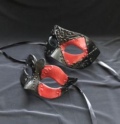 This unique couple's masquerade masks are great for any Venetian mask party or masquerade ball. the women and men's masks are hand painted black and red with raised detail.   Masks are light weight and have a comfortable fit. They also come with black silk ribbon ties attached. Black Masks And Prosthetics For Carnival Cosplay, Black Masks And Prosthetics For Cosplay Carnival, Black Masquerade Mask For Carnival Cosplay, Black Masquerade Mask For Halloween Theater, Black Halloween Masquerade Mask For Theater, Black Masks For Cosplay Carnival, Gothic Masquerade Eye Mask For Theater, Black Mask For Cosplay Carnival, Black Venetian Mask For Masquerade