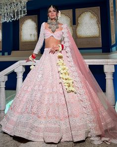 Reverie Bridal set is a stunning coral pink lehenga hand embroidered on pure raw silk fabric with signature glass crystals, pearls, sequins, and beads and has scalloped edges on the lehenga. It's paired with an attractive hand-embroidered blouse with cap sleeves on net fabric. It comes with a peachy pink soft net scall Pink Hand Embellished Anarkali Traditional Wear, Hand Embellished Pink Anarkali Traditional Wear, Pink Hand Embellished Lehenga For Festivals, Pink Hand Embellished Anarkali Set For Wedding, Traditional Pink Hand Embellished Dupatta, Hand Embellished Pink Anarkali Set For Wedding, Traditional Hand Embellished Pink Dupatta, Pink Hand Embellished Lehenga With Traditional Drape, Elegant Pink Hand Embellished Traditional Wear