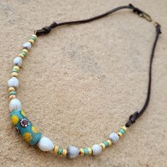 This necklace is strung with a central focal bead that is a vibrant Krobo powder glass bead from Africa. There is also beautiful, natural Job's Tears seed beads. This necklace is finished with super soft dear suede leather. I love this combination, and I hope you do too! If you like this necklace, you might also like: https://www.etsy.com/Fantangodesigns/listing/1303068477/african-krobo-beads-with-jobs-tears-and?utm_source=Copy&utm_medium=ListingManager&utm_campaign=Share&utm_term=so.lmsm&share_time=1663426542360 Colorful Beaded Necklace Of Recycled Glass For Gifts, Colorful Recycled Glass Beaded Necklace As Gift, Adjustable Beaded Recycled Glass Necklace, Adjustable Artisan Czech Glass Beads, Bohemian Czech Glass Beads With Large Beads, Artisan Czech Glass Beads Adjustable, Adjustable Bohemian Hand-strung Beaded Necklace, Bohemian Czech Glass Large Beads, Hand-strung Bohemian Beaded Necklaces For Festivals