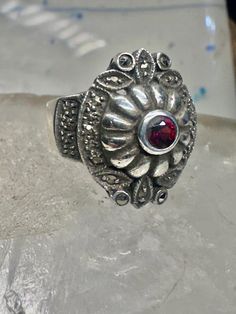 Art Deco ring marcasite band garnet Solid band Size 4.50 sterling silver women girls Size 4.50 Weight. 8.5g  Length  3/4" Width 5/8"" Band in Back  3/16" Free Shipping & Free Postal Insurance  Delivered in a Gift Box  Free First Class shipping and postal insurance is included. If you want to upgrade to priority kindly pay an additional fee to do so.  This is recommended if you would like to have your package delivered faster than first class which has slowed down Victorian Silver Jewelry With Decorative Band, Antique Silver Ring With Decorative Band, Antique Silver Rings With Decorative Band, Silver Garnet Ring Stamped 925, Marcasite Anniversary Rings Stamped 925, Ornate Garnet Round Rings, Ornate Round Garnet Rings, Vintage Garnet Jewelry Stamped 925, Vintage Marcasite Ring Stamped 925