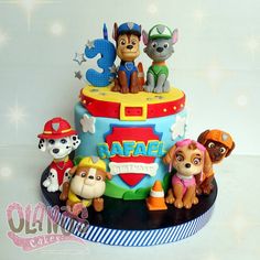 a birthday cake decorated with the characters of paw patrol