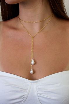 The Breathless Tie Lariat Necklace features a 36" signature brisbane chain with genuine baroque freshwater pearl ends. Designed to be worn different ways, wrap it twice and cross the ends or wear it long and cross the middle.  Lightweight and comfortable to wear.  Materials: 14K gold filled or sterling silver Closure: Beach Wedding Jewelry, Elizabeth Jewelry, Pearl Lariat Necklace, Lariat Necklace, Dainty Jewelry, Cute Jewelry, Pearl Jewelry, Jewelry Inspiration, Bridal Jewelry