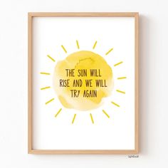 the sun will rise and we will try again print in a wooden frame on a wall