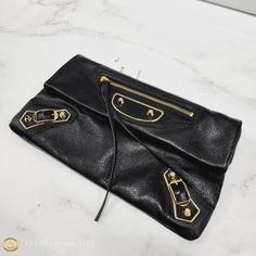 Sold Out Everywhere In Nwt Condition! This Balenciaga Chevre Leather Envelope Clutch Should Be Your Next Purchase. Highlights: 100% Authentic. Condition: New With Tags Gender: Women Color: Black Bag Type: Clutch Material: Leather. Main Fastening: Magnetic Button Closure. Handles: Extra Shoulder Strap. Inside: 2 Lined Compartments. Internal Pockets: 1 Zipper Compartment. Style Code: 438791aq40g - 1000 Msrp $1295 Made In Italy. Phone Fit: Fits Iphone 15 Pro Max Comes With: Dust Bag. Dimensions: Wi Designer Travel Clutch, Designer Business Clutch With Gold-tone Hardware, Designer Black Clutch, Designer Travel Clutch With Gold-tone Hardware, Designer Black Envelope Clutch, Balenciaga Hourglass Wallet, Balenciaga Envelope Clutch, Balenciaga Wallet On Chain, Balenciaga Wallet