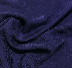 an image of a blue fabric with paisley designs on it's side, close up