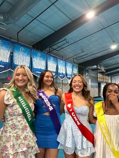 four beautiful young women standing next to each other