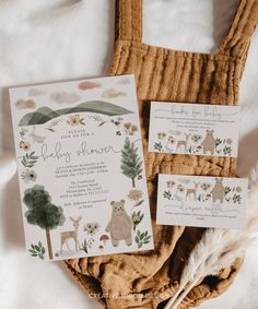 the wedding stationery is laid out on top of a bed with an animal theme