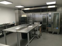 an industrial kitchen with stainless steel appliances and counters