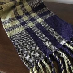 a blue and white checkered blanket sitting on top of a wooden table