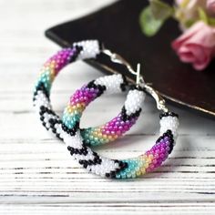 White and Purple Hoop Earrings 1.6", Big Beaded Hoops, Nativ - Inspire Uplift Summer Hoop Earrings With Colorful Beads, Handmade Colorful Hoop Earrings For Summer, Colorful Handmade Hoop Earrings For Summer, Trendy Handmade Multicolor Hoop Earrings, Handmade Colorful Summer Hoop Earrings, Trendy Multicolor Handmade Hoop Earrings, Multicolor Hoop Earrings With Large Beads As Gift, Handmade White Hoop Earrings For Summer, Handmade Colorful Beaded Hoop Earrings